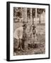 Woman and Young Boy Tap Rubber Trees in Malaya and Collect the Sap in Buckets-null-Framed Photographic Print