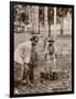 Woman and Young Boy Tap Rubber Trees in Malaya and Collect the Sap in Buckets-null-Framed Photographic Print