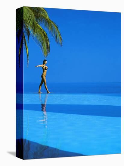 Woman Balancing on Edge of Infinity Pool, Maldives, Indian Ocean-Papadopoulos Sakis-Stretched Canvas