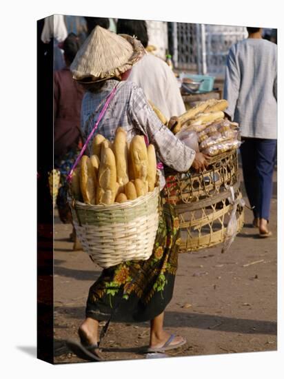 Woman Carrying Baskets of French Bread, Talaat Sao Market in Vientiane, Laos, Southeast Asia-Alain Evrard-Stretched Canvas