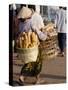 Woman Carrying Baskets of French Bread, Talaat Sao Market in Vientiane, Laos, Southeast Asia-Alain Evrard-Stretched Canvas