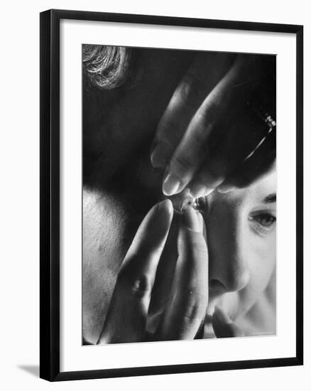 Woman Cautiously Placing a Contact Lens in Her Eye-Al Fenn-Framed Photographic Print