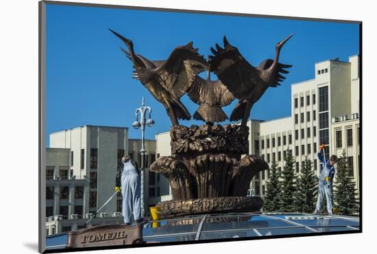 Woman Cleaning a Giant Bird Statue-Michael Runkel-Mounted Photographic Print