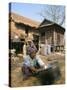Woman Cleaning Pot Outside Her House, Near Siem Reap, Cambodia, Indochina, Southeast Asia-Jane Sweeney-Stretched Canvas
