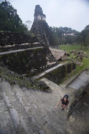 https://imgc.allpostersimages.com/img/posters/woman-climbing-stairs-at-mayan-archaeological-site-tikalguatemala-central-america_u-L-PSY18P0.jpg?artPerspective=n