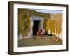 Woman Cooking Outside House with Painted Walls, Village Near Jaisalmer, Rajasthan State, India-Bruno Morandi-Framed Photographic Print