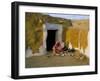 Woman Cooking Outside House with Painted Walls, Village Near Jaisalmer, Rajasthan State, India-Bruno Morandi-Framed Photographic Print