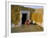 Woman Cooking Outside House with Painted Walls, Village Near Jaisalmer, Rajasthan State, India-Bruno Morandi-Framed Photographic Print