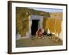 Woman Cooking Outside House with Painted Walls, Village Near Jaisalmer, Rajasthan State, India-Bruno Morandi-Framed Photographic Print