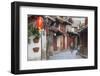 Woman cycling along alleyway, Lijiang (UNESCO World Heritage Site), Yunnan, China-Ian Trower-Framed Photographic Print