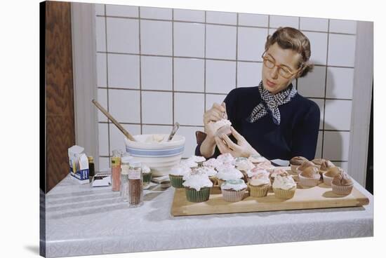 Woman Decorating Cup Cakes-William P. Gottlieb-Stretched Canvas