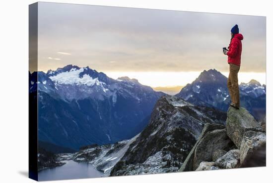 Woman Drinks Her Coffee On Top Of A Mountain In The Morning Looking Out Into The Cascade Mts In WA-Hannah Dewey-Stretched Canvas