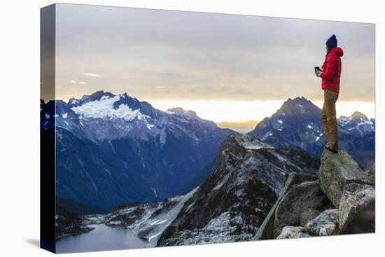 Woman Drinks Her Coffee On Top Of A Mountain In The Morning Looking Out Into The Cascade Mts In WA-Hannah Dewey-Stretched Canvas