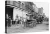 Woman Driving Horse-Drawn Wagon on Street-null-Stretched Canvas