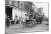 Woman Driving Horse-Drawn Wagon on Street-null-Mounted Photographic Print