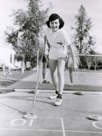 'Woman Enjoying a Game of Shuffleboard' Photo | AllPosters.com