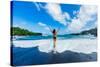 Woman enjoying the sun on one of Maui's black sand beaches, Maui, Hawaii-Laura Grier-Stretched Canvas