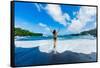 Woman enjoying the sun on one of Maui's black sand beaches, Maui, Hawaii-Laura Grier-Framed Stretched Canvas