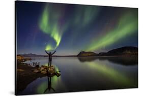 Woman Enjoying the View of the Northern Lights, at Lake Thingvellir, Iceland-null-Stretched Canvas