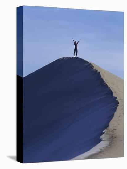Woman Exercising on the Top of a Sand Dune-null-Stretched Canvas