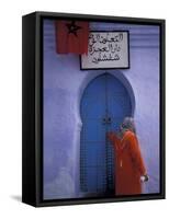 Woman Exits thru Moorish-Style Blue Door, Morocco-Merrill Images-Framed Stretched Canvas