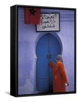 Woman Exits thru Moorish-Style Blue Door, Morocco-Merrill Images-Framed Stretched Canvas
