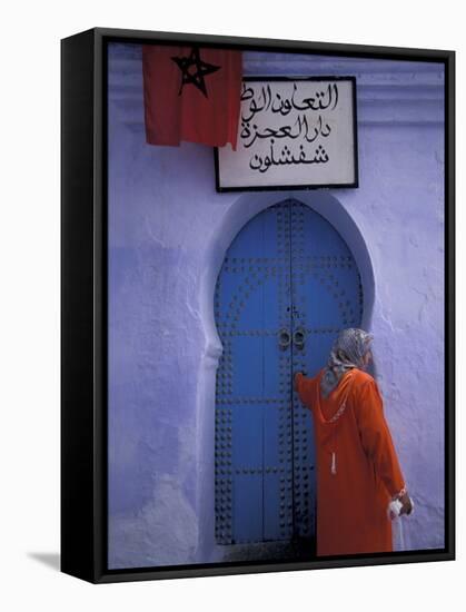 Woman Exits thru Moorish-Style Blue Door, Morocco-Merrill Images-Framed Stretched Canvas