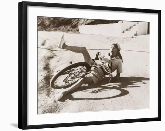 Woman Falling Off Her Bicycle on Side of Road-null-Framed Photo