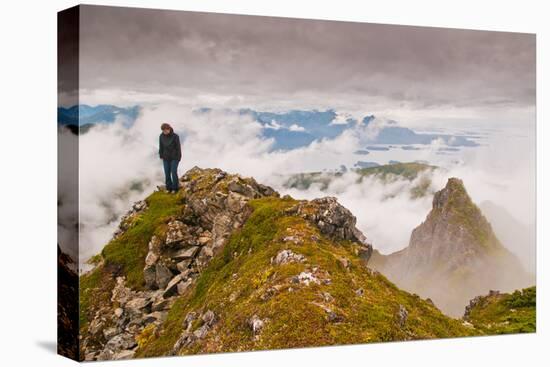 Woman high atop cloudy Harbor Mountain, Sitka, Alaska-Mark A Johnson-Stretched Canvas