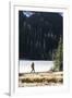 Woman Hiker Walks Alongside A Frozen Lake In The Olympic Mountain High Country During Winter In WA-Hannah Dewey-Framed Photographic Print