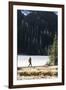 Woman Hiker Walks Alongside A Frozen Lake In The Olympic Mountain High Country During Winter In WA-Hannah Dewey-Framed Photographic Print