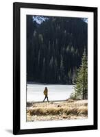 Woman Hiker Walks Alongside A Frozen Lake In The Olympic Mountain High Country During Winter In WA-Hannah Dewey-Framed Photographic Print