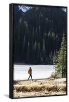 Woman Hiker Walks Alongside A Frozen Lake In The Olympic Mountain High Country During Winter In WA-Hannah Dewey-Framed Photographic Print