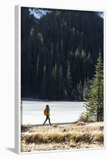 Woman Hiker Walks Alongside A Frozen Lake In The Olympic Mountain High Country During Winter In WA-Hannah Dewey-Framed Photographic Print