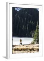 Woman Hiker Walks Alongside A Frozen Lake In The Olympic Mountain High Country During Winter In WA-Hannah Dewey-Framed Photographic Print