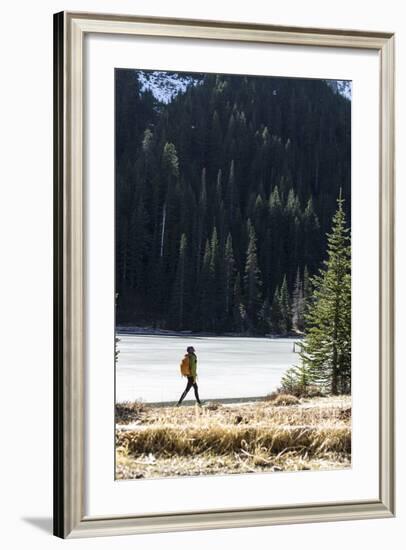 Woman Hiker Walks Alongside A Frozen Lake In The Olympic Mountain High Country During Winter In WA-Hannah Dewey-Framed Photographic Print