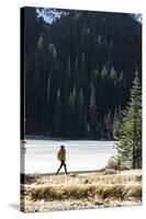 Woman Hiker Walks Alongside A Frozen Lake In The Olympic Mountain High Country During Winter In WA-Hannah Dewey-Stretched Canvas