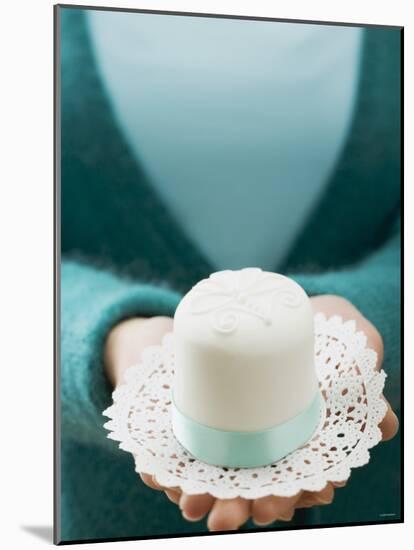 Woman Holding a Small White Cake on a Doily-null-Mounted Photographic Print