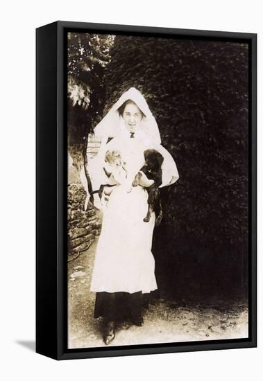 Woman Holding Two Puppies in a Garden-null-Framed Stretched Canvas