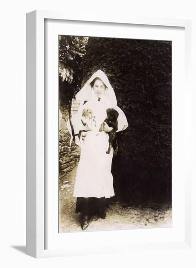 Woman Holding Two Puppies in a Garden-null-Framed Photographic Print