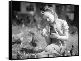 Woman Holds Chicken for Feeding-Philip Gendreau-Framed Stretched Canvas