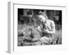 Woman Holds Chicken for Feeding-Philip Gendreau-Framed Premium Photographic Print