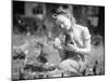 Woman Holds Chicken for Feeding-Philip Gendreau-Mounted Premium Photographic Print