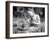 Woman Holds Chicken for Feeding-Philip Gendreau-Framed Photographic Print