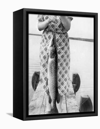 Woman Holds on Large Northern Pike on a Lake Pier, Ca. 1950-null-Framed Stretched Canvas