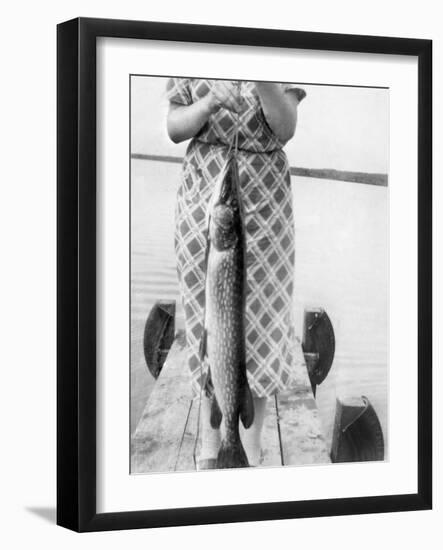 Woman Holds on Large Northern Pike on a Lake Pier, Ca. 1950-null-Framed Photographic Print