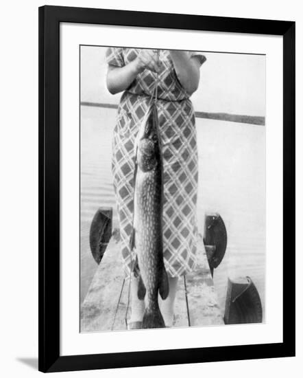 Woman Holds on Large Northern Pike on a Lake Pier, Ca. 1950-null-Framed Photographic Print