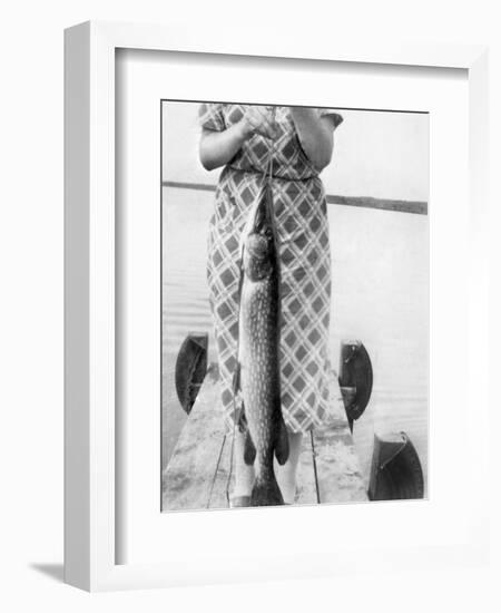 Woman Holds on Large Northern Pike on a Lake Pier, Ca. 1950-null-Framed Photographic Print