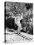 Woman in a Bathing Suit Skiing Down a Hill-null-Stretched Canvas