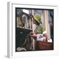 Woman in a Green Floppy Hat and Green Dress Browses in a Shop Selling Various Mirrors and Ornaments-null-Framed Art Print